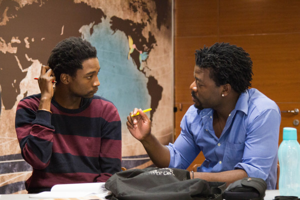 Photo: African youth leaders Sabelo Mnukwa and Felix Luis Carlos discuss Disaster Risk Reduction strategies onboard Peace Boat. (Joseph Hincks)