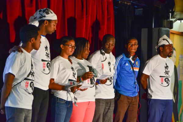 Photo: The six African youth leaders, and UNISDR’s DRR Africa Youth Champions Coordinator Raphael Obonyo, read out The Peace Boat Declaration in the ship’s Broadway Theatre. (Photo: Airi Katsuta)